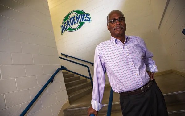 Former educator and State Rep. John W. Buckner stands at Overland High School, where he served as principal and helped shape generations of Aurora students.